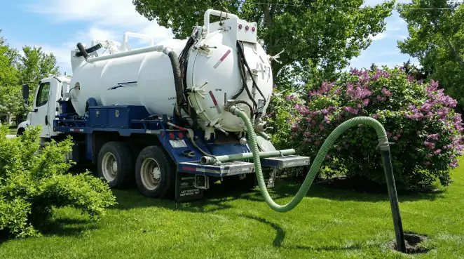Professional vacuum truck performing residential drainage and septic maintenance in Overland Park, KS