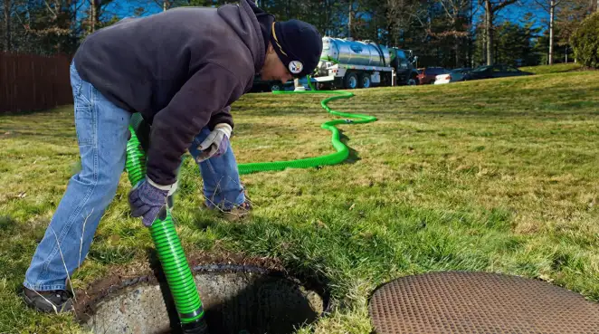 Service technician performing residential septic pumping and drainage maintenance in Overland Park, KS